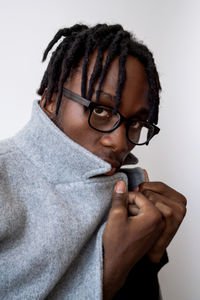 Stylish black man wearing glasses and coat portrait