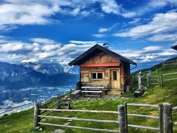 House on mountain against sky