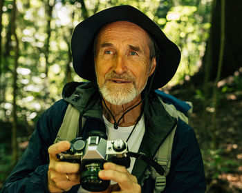 Portrait of woman photographing through camera