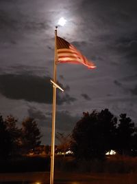 Low angle view of flag against sky at night