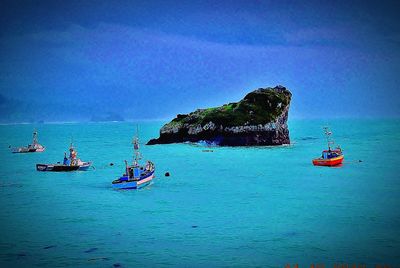 Boats in sea against sky