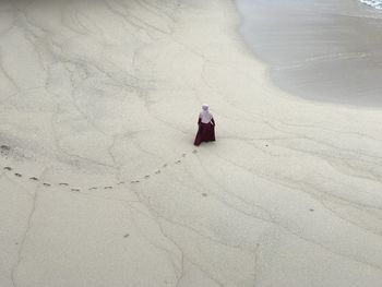 High angle view of woman walking on beach