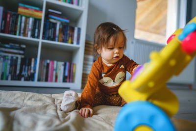 Boy playing with toy while sitting at home