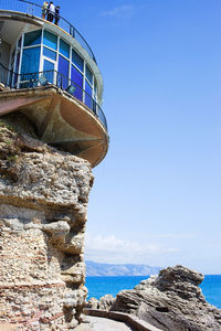 Low angle view of rocks on beach against sky