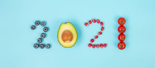 High angle view of fruits against blue background