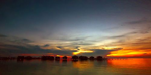 Scenic view of dramatic sky over sea during sunset