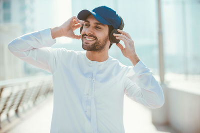 Young man wearing hat standing outdoors