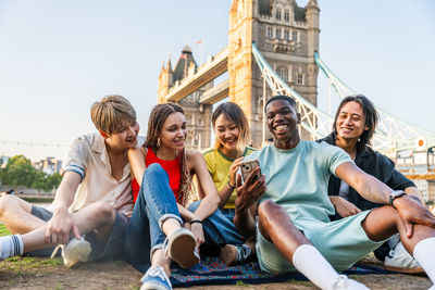 Portrait of smiling friends sitting on sofa