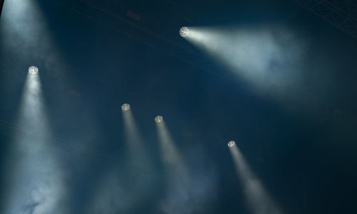 Projectors light beam through smoke