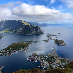 Aerial view of sea and buildings against sky