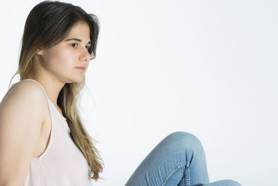 Portrait of a young woman sitting outdoors