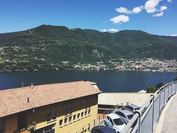 Buildings by mountains against sky