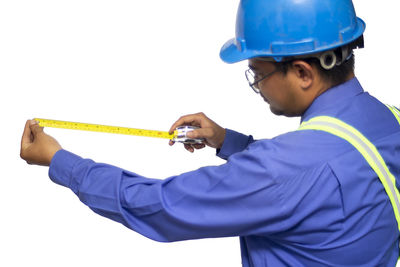 Man working against blue background