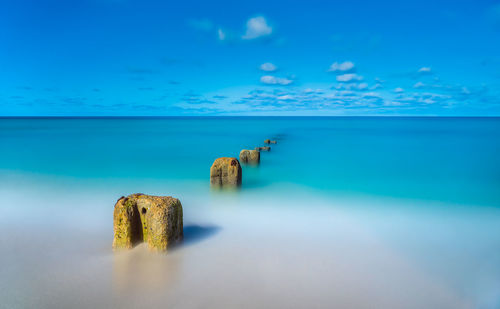 Scenic view of sea against blue sky