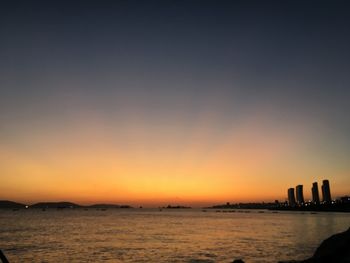 Scenic view of sea against orange sky