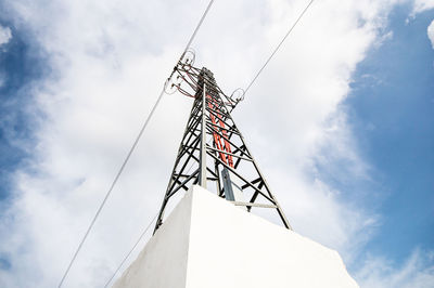 Low angle view of telephone pole against sky