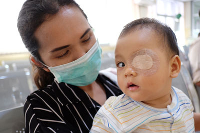 Close-up of baby boy with bandage on eye