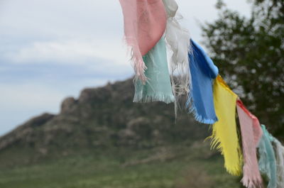 Close-up of multi colored fabric against sky