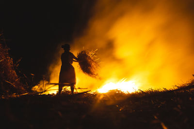 Man burning fire at night