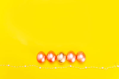 Close-up of berries on water against yellow background