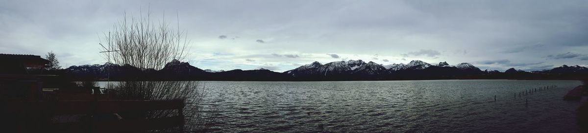 Scenic view of lake against cloudy sky