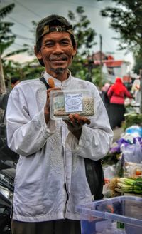 Portrait of man holding paper currency