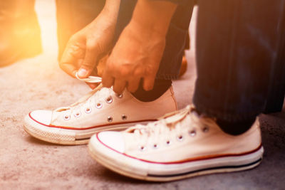 Low section of man wearing shoes