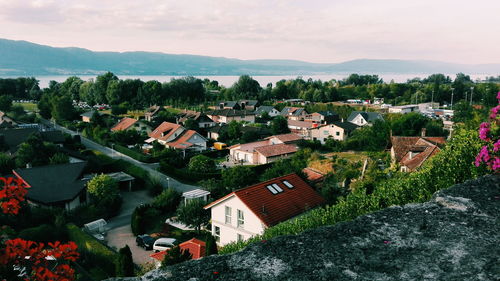 High angle view of houses in town against sky