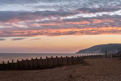 Scenic view of beach against sky during sunset