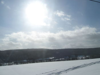 Scenic view of landscape against sky during winter