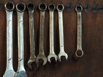 Close-up of work tools hanging side by side in workshop
