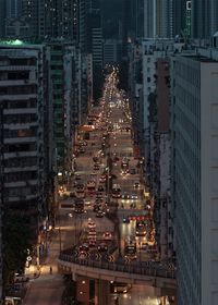 High angle view of illuminated city street and buildings at night