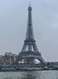 Low angle view of city of paris under snow at waterfront 