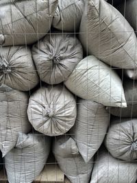 Full frame shot of stacked sacks in warehouse