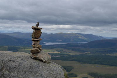 Statue on mountain against sky