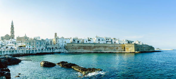 View of buildings and sea against sky