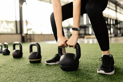 Low section of woman exercising at gym