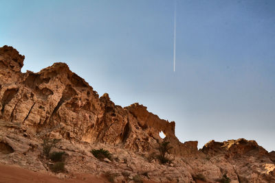 Low angle view of rock formation against clear sky