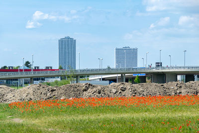 View of construction site by buildings against sky