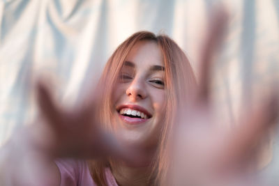 Young woman with red hair smiling and joking