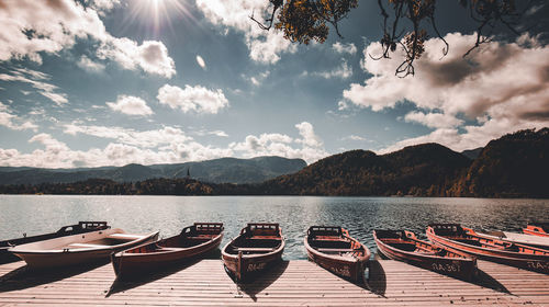 Boats moored in lake against sky