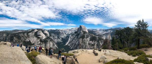 Group of people on mountain against sky