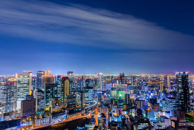 High angle view of city lit up at night