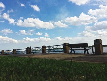 Footpath by river against sky