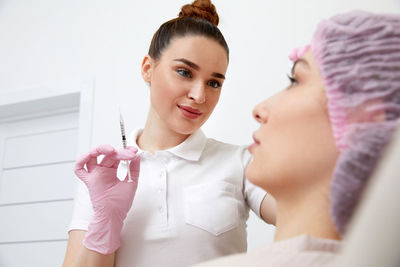 Female doctor examining patient at home