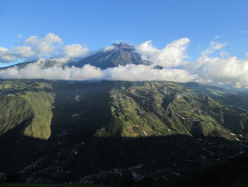 Scenic view of mountain peak surrounded by clouds