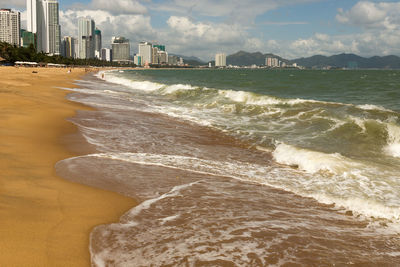 Scenic view of sea and buildings against sky