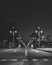 Illuminated empty road at night