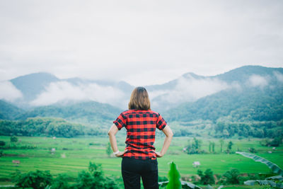 Rear view of man looking at mountains