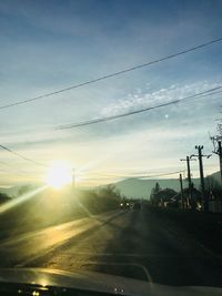 Road against sky seen through car windshield